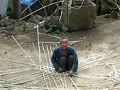 An old man weaving bamboo containers