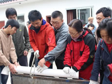 Learning to build rain collection devices in the permaculture training course in Sichuan.