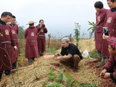 Trainer carefully explaining technical skills in no-dig farming in permaculture class conducted in Sichuan.