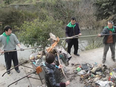 Local people are mobilised to clear the garbage along the river Heishuitan River in Chongqing.